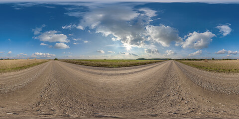 Fototapeta na wymiar full hdri 360 panorama on no traffic gravel road among fields with overcast sky and white fluffy clouds in equirectangular seamless spherical projection,can be used as replacement for sky in panoramas