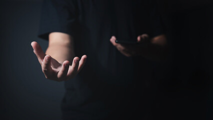 Male empty hand open a palm up on a dark background.