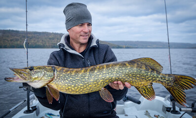Angler with swedish lake pike