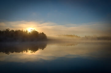 Sunrise over the foggy lake - 541025062