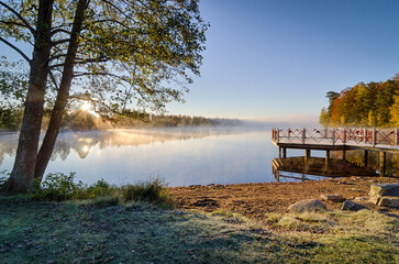 Swedish autumn lake in sunrise scenery