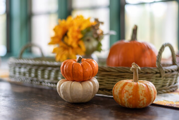 Thanksgiving background with soft focus pumpkins on a rustic table