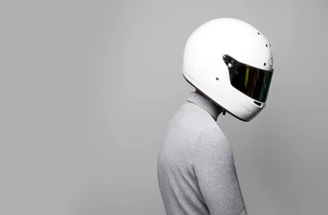Foto op Canvas Driver posing with helmet. Stylish Male Pilot Model isolated on grey background. Close Up of F1 Racer  © Studiofy
