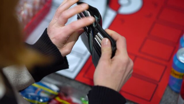 Woman looks for money in empty purse