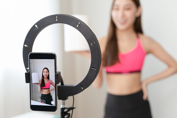 Asia healthy beautiful blogger influencer showing plant-based protein whey product on her live streaming channel to viral marketing brand online in wellness group follower.