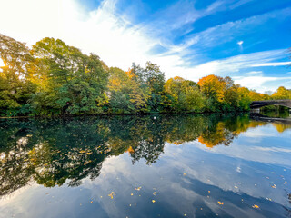 Autumn landscape along one of the many waterways that run through Hamburg. The river Wandse become...