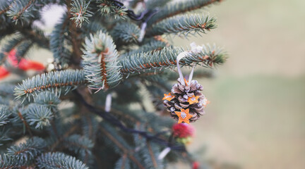 DIY handmade pine cone decoration on a Christmas tree