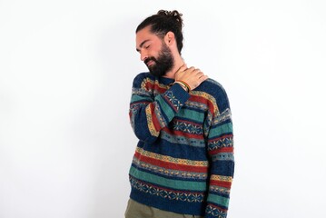 Fototapeta premium Caucasian man with beard wearing sweater over white background got back pain