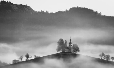 Cerkev Sveti Tomaž (St. Thomas Church) near Škofja Loka, Slovenia. Misty morning and sunrise