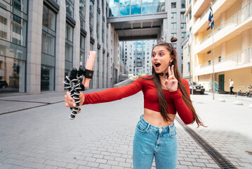 Young female blogger with smartphone streaming on the street.