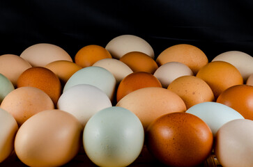 Chicken eggs on a flat surface on a black background.