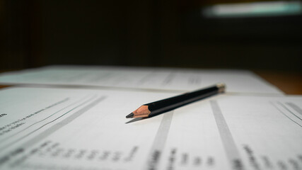 Black marking on checklist box with pencil close up. Checklist concept