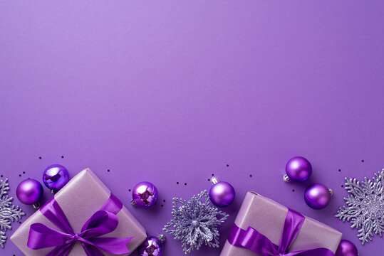 Christmas Eve concept. Top view photo of lilac gift boxes with ribbon bows flower ornaments violet baubles and confetti on isolated purple background with empty space