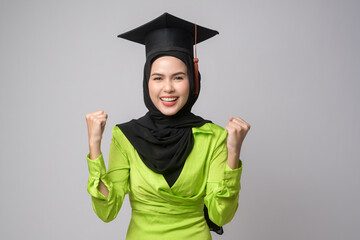 Young smiling muslim woman with hijab wearing graduation hat, education and university concept.