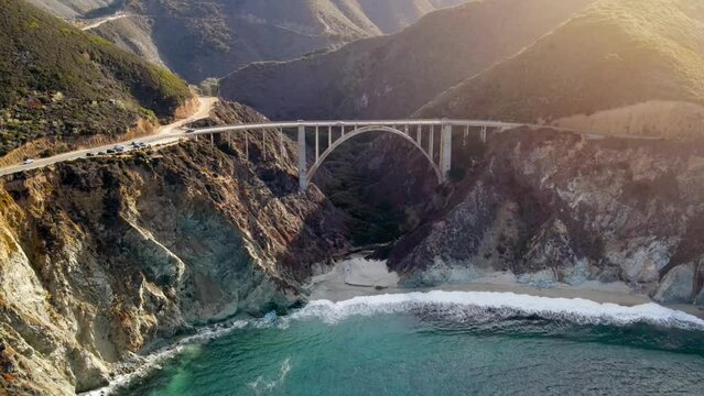 Aerial of the rugged coastline of Big Sur California. The Pacific Coast Highway and the famous Bixby Creek Bridge can be seen.