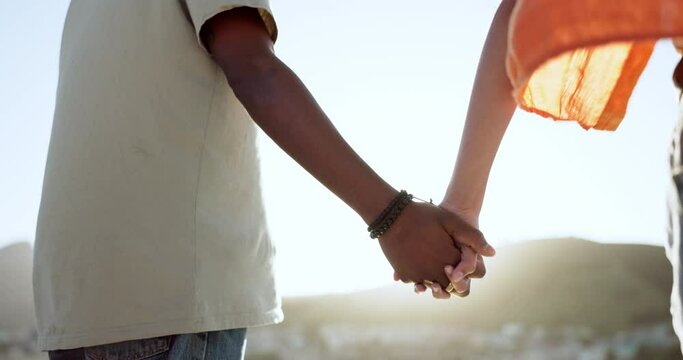Interracial couple, bonding or holding hands in support, trust or security in Lisbon city, Portugal. Zoom, black man or woman in solidarity, love or unity on summer holiday vacation in relax location