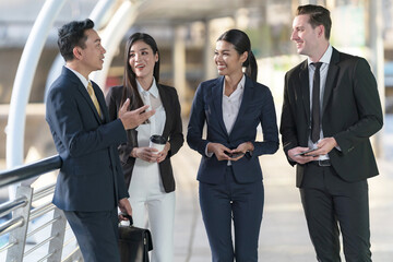 Business people walking and talk to each other in front of modern office