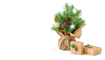 Naklejka na ściany i meble Composition from Christmas tree branches, pine cone and snowflakes in craft wrapping paper with craft gift boxes on white background with copy space