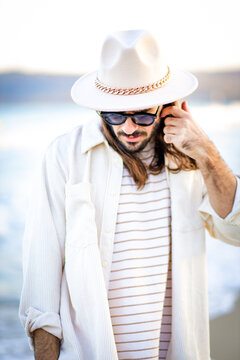 beautiful man in hat on the beach in varna bulgaria, model shooting