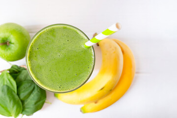 Banana mix spinach apple fresh cocktail smoothies  fruit juice beverage healthy the taste yummy in glass drink episode good morning on wooden background from the top view.