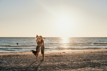 couple in love kissing on beach at sunset