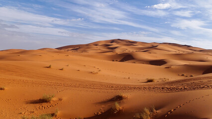 Fototapeta na wymiar Amazing view of beautiful Sand dunes of the Sahara desert with a sky in the background, Morocco