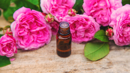 Rose essential oil in a bottle. Selective focus.