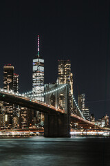 New York brooklyn bridge on front of the One Word Trade center at night