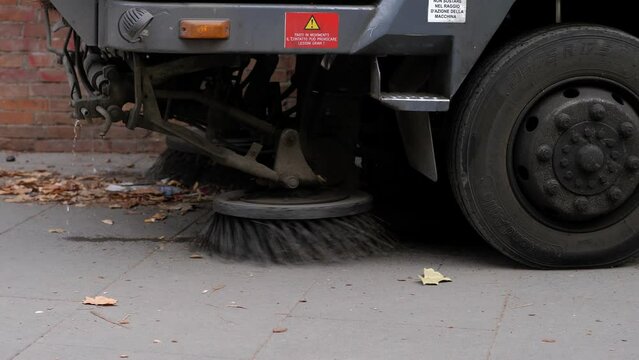 A street sweeper truck diligently cleans the road, a testament to urban cleanliness and the ongoing effort to maintain public spaces