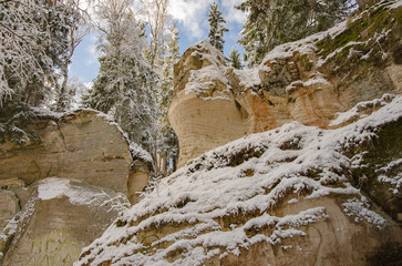 Naklejka na ściany i meble snow covered rocks in the forest