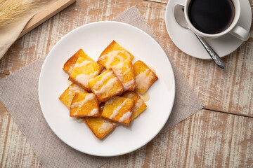 Sliced Air fryer grilled butter toast,golden brown crispy bread topped with sugar and sweetened condensed milk on white plate