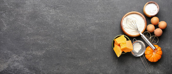 Ingredients for preparing pumpkin pie on dark background with space for text, top view