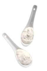 Spoons with Caesar sauce on white background
