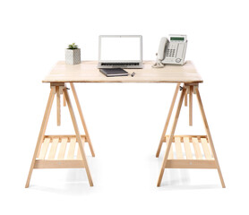 Wooden standing desk with laptop, houseplant, notebook and landline phone on white background