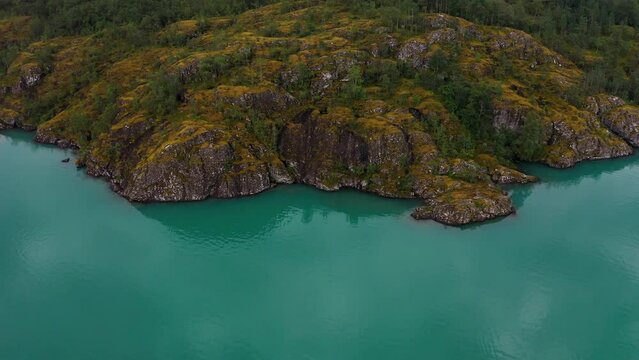 Lake bottom Loenvatnet with glacial river starting to flow dowm Lodalen valley. moving aerial