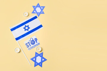 Burning candles, flag of Israel and card with text STOP TERRORISM on color background