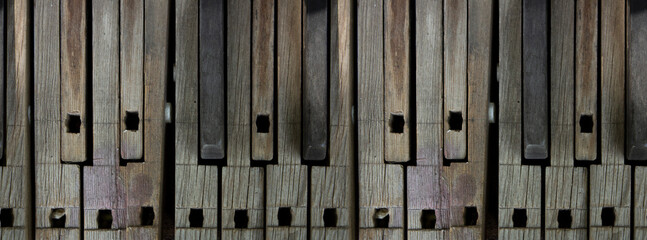 Seamless pattern with wooden keys of an old broken out of tune piano. Vintage piano keys. Banner...