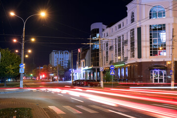 View of city road with street lights and buildings at night