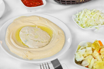 Plate with tasty hummus on table in restaurant, closeup