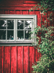 Window in a red, wooden Swedish summer house