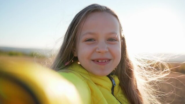 Little cute girl holds device recording video make videoblog, pose take selfie, close up webcam view. Family looking at camera enjoy video call. Family bond, modern tech, fun concept