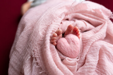 legs of a newborn baby. heart at the feet