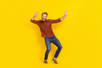 Fototapeta na wymiar Full body photo of satisfied cool person raise hands enjoy clubbing isolated on yellow color background