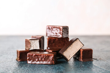 Heap of tasty bird's milk candies on dark color table