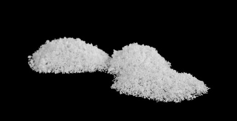 Heaps of white snow isolated on a black background.