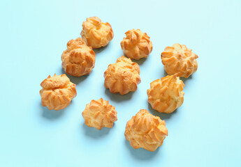 Composition with delicious eclairs on color background