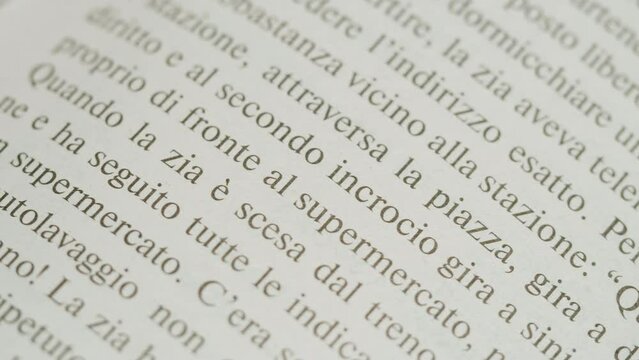 Flipping Spanish language book pages, reading and education, Flicking Through Old textbook Close-up, macro shot of paper in university library.