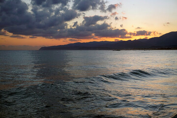 Sunrise behind the mountains over the Aegean Sea. October morning. The magic of nature	