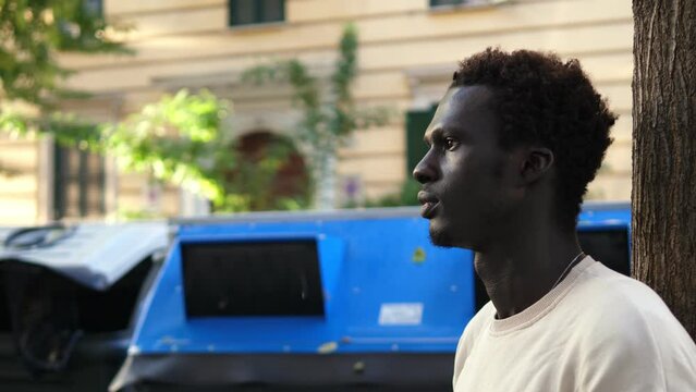 Concept of being alone among people: handsome clack man in the city alone