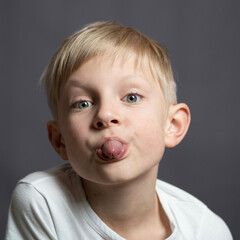 Studio portrait of  a blue-eyed blonde caucasian boy